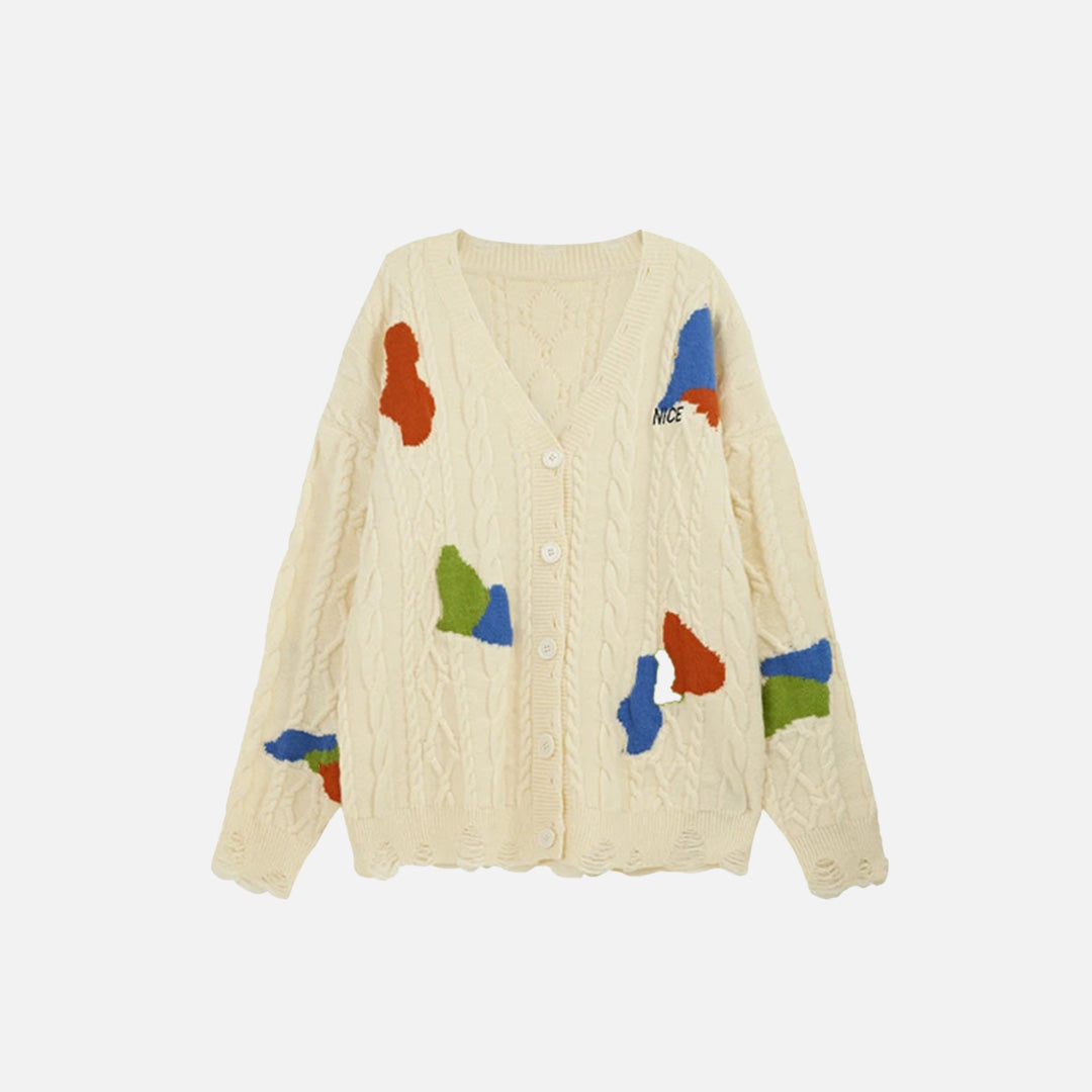 Front view of the apricot Abstract Patch Cable Knit Sweater in a gray background