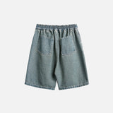 Back view of the blue Divine Print Denim Shorts in a gray background