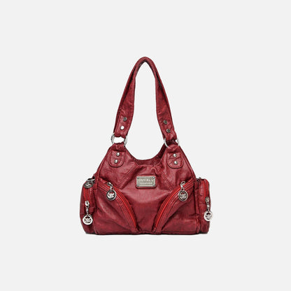 Front view of the burgundy Utility Wanderer Handbag in a gray background