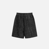 Back view of the black Modern Speckled Drawstring Shorts in a gray background 
