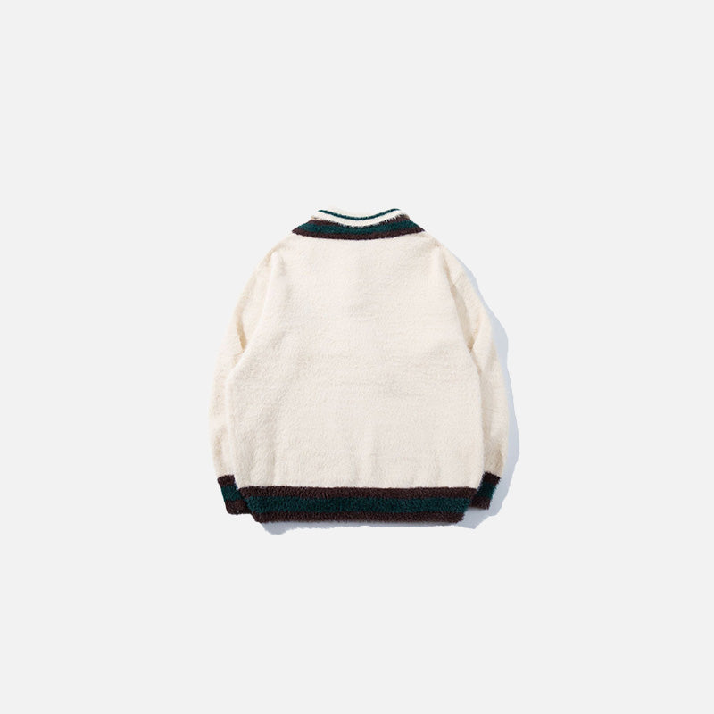Back view of the apricot Preppy Tie Sweater in a gray background