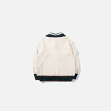 Back view of the apricot Preppy Tie Sweater in a gray background