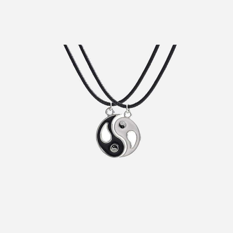 Front view of the Yin-Yang Puzzle Pendant Necklace in a gray background
