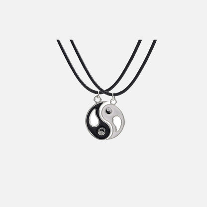 Front view of the Yin-Yang Puzzle Pendant Necklace in a gray background