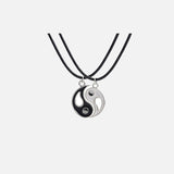 Front view of the Yin-Yang Puzzle Pendant Necklace in a gray background