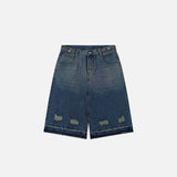 Front view of the blue Y2k Ripped Washed Jorts in a gray background
