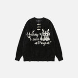 Front view of the black Vintage Loose Dragon Sweater in a gray background 