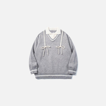 Front view of the grey Vintage Drawstring Oversized Sweater in a gray background