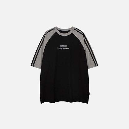 Front view of the black Loose Side Striped T-shirt in a gray background 