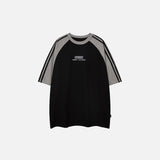 Front view of the black Loose Side Striped T-shirt in a gray background 