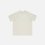 Front view of the milk tea white Loose Patchwork Oversized T-shirt in a gray background 