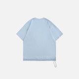 Back view of the blue Y2k Loose Pocket T-shirt in a gray background