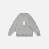 Front view of the grey Number 9 Embroidered Sweatshirt in a gray background