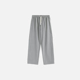 Front view of the grey Drawstring Wide-Leg Pants in a gray background