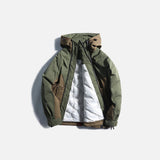 Front view of the army green Summit Explorer Jacket in a gray background