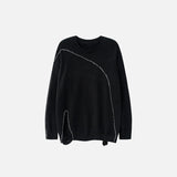 Front view of the black Loose Knitted Ripped Sweater in a gray background