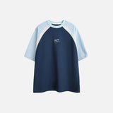 Front view of the blue Classic Raglan T-shirt in a gray background