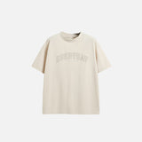 Front view of the apricot Embroidered Loose T-shirt in a gray background 