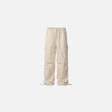 Front view of the apricot Utility Cargo Pants in a gray background