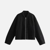 Front view of the black Ethereal Quilted Embrace Jacket in a gray background