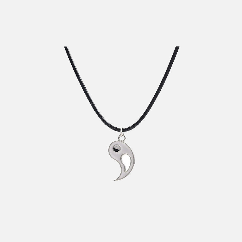 Front view of the Yin-Yang Puzzle Pendant Necklace in a gray background