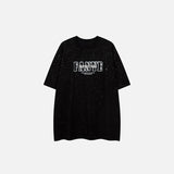 Front view of the black Fantasy Glitter Loose T-shirt in a gray background 