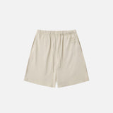 Front view of the beige Letter Print Loose Shorts in a gray background 