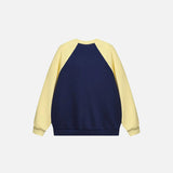 Back view of the blue Y2K Loose Patchwork Sports Sweatshirt in a gray background