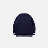 Back view of the navy blue Vintage Drawstring Oversized Sweater in a gray background