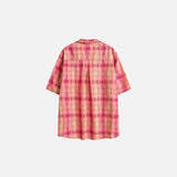 Front view of the pink Women's Plaid Short-Sleeve Shirt in a gray background