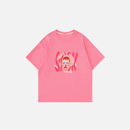 Front view of the pink Artistic Face Print Oversized T-shirt in a gray background