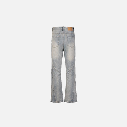 Back view of the blue Vintage Inspired Distressed Flare Jeans in a gray background