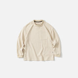 Front view of the beige Timeless Pocket Sweatshirt in a gray background