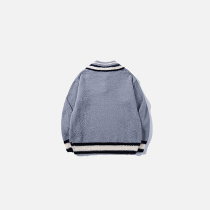 Back view of the blue Preppy Tie Sweater in a gray background