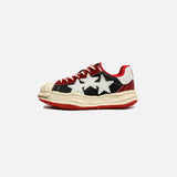 Side View of the red Star Bust Runner Shoes  in a gray background