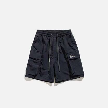 Front view of the navy Essential Utility Cargo Shorts in a gray background