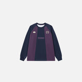 Front view of the purple Elite Crest Long Sleeve T-shirt in a gray background