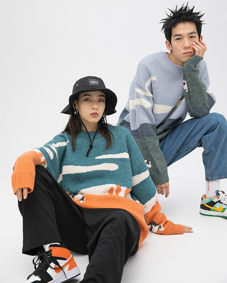 A guy and a girl wearing Dutch landscape sweater