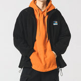Model wearing the black Heritage Fleece Zip-Up Jacket in a gray background