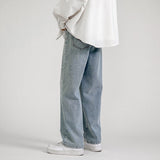White long-sleeve shirt, wide light blue jeans, white Nike shoes, white background.