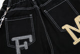 DAXUEN Black wide-leg denim shorts with appliqué details