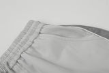 DAXUEN Wide-leg track pants with geometric color-blocked panels
