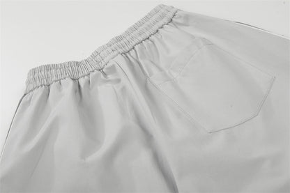 DAXUEN Wide-leg track pants with geometric color-blocked panels