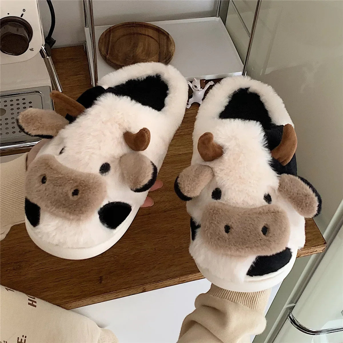 Model wearing the white Cow Slippers