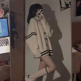 Front view of the beige Buttoned Varsity Sweater 