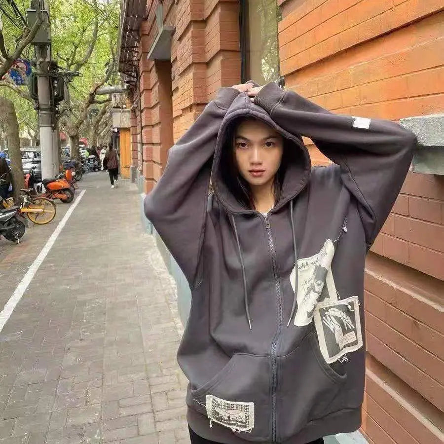 Model wearing the gray Graphic Patchwork Zip-Up Sweatshirt