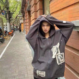 Model wearing the gray Graphic Patchwork Zip-Up Sweatshirt