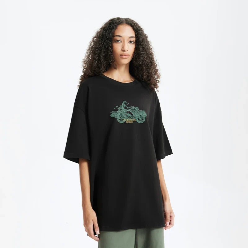 Model wearing the black Bold Graphic T-Shirt in a gray background 
