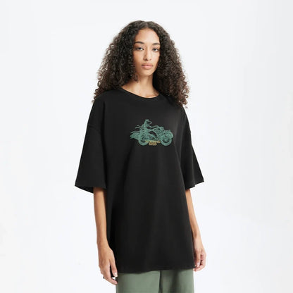 Model wearing the black Bold Graphic T-Shirt in a gray background 