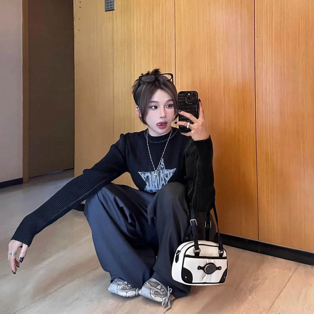 Model wearing the black Y2K Starbrust Sweatshirt 
